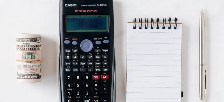 calculator, notepad, and a pen, representing a way to get your security deposit back