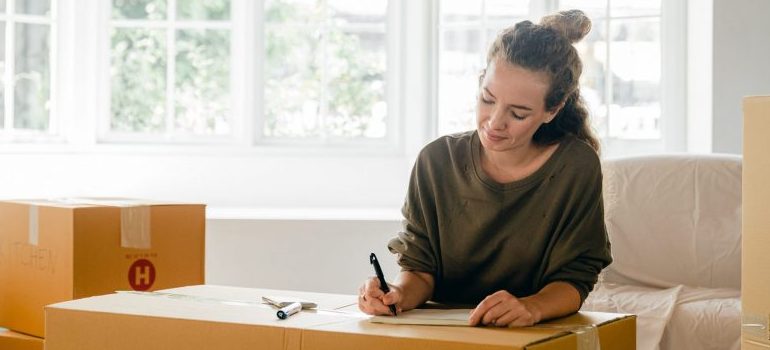 person writing a packing inventory list