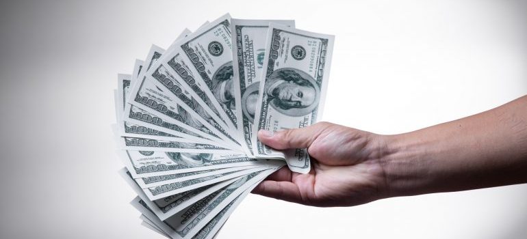 someone holding us dollars