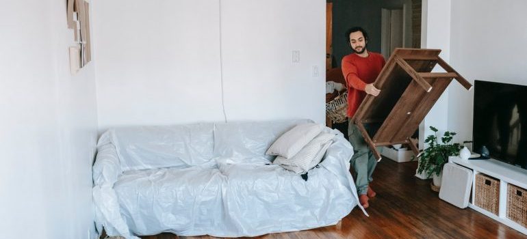 A person moving furniture