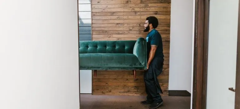 Workers take care to protect walls and floors when moving.