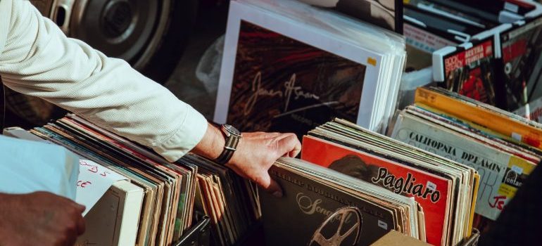 a person picking old records on a garage sale