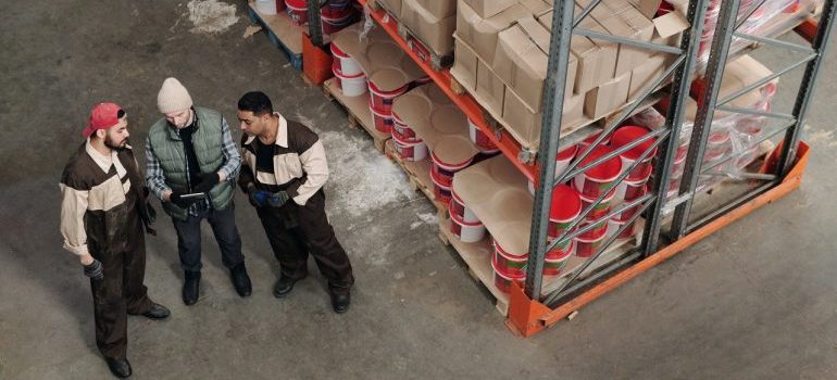 a group of people talking in a warehouse