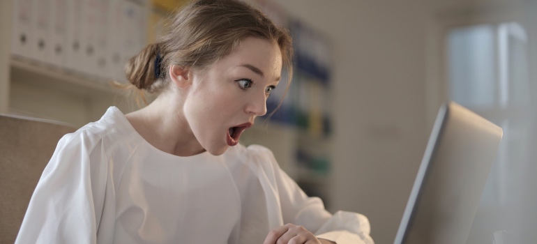 A woman looking at a unexpected shipping invoice