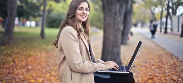 A woman in the park with a laptop