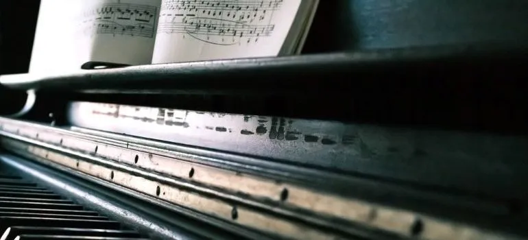 black piano with sheet music