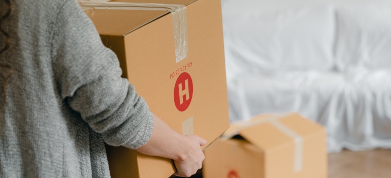 a woman carrying box