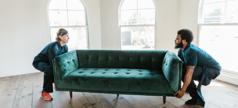 Workers carry a sofa