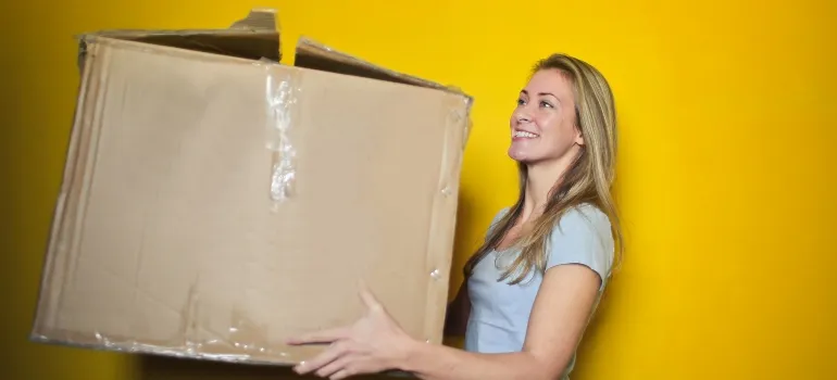 a woman holding a box