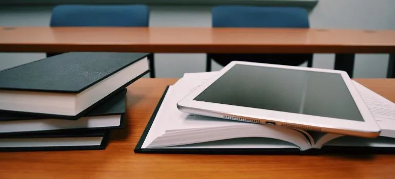 a tablet on top of college books