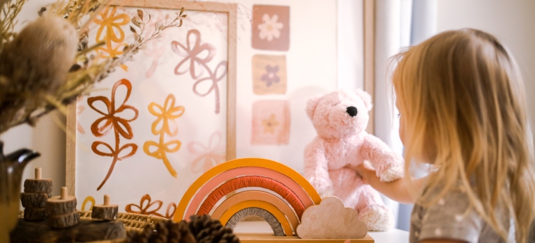 A little girl playing with a toy in her room