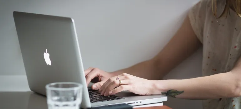 person using a computer for planning a moving budget