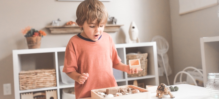 A boy playing with toys in his room