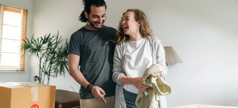 happy couple packing before moving from Washington to California