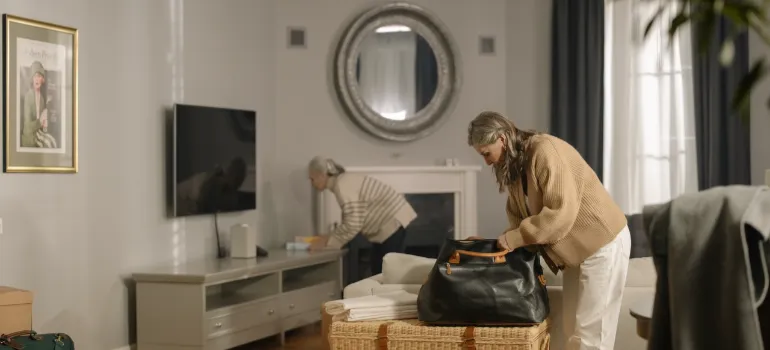 a woman putting stuff in a bag