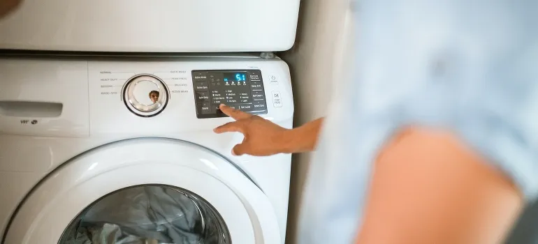 A person turns on washing machine