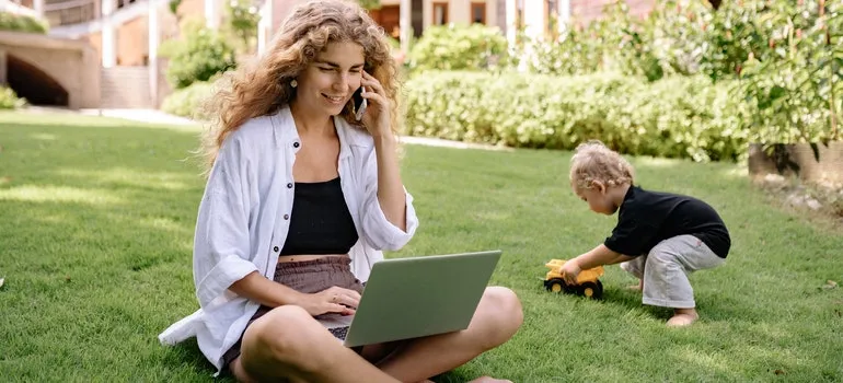 Woman using laptop and talking on the phone