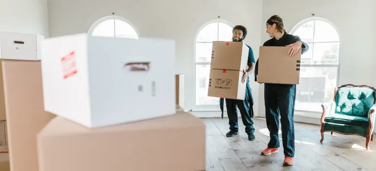 two guys carrying boxes