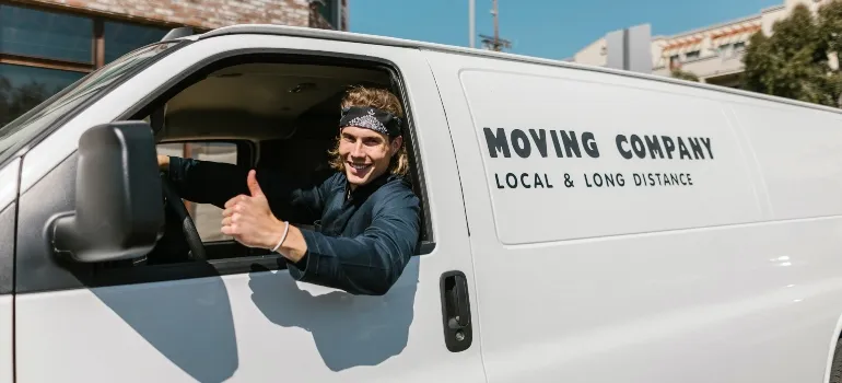 happy guy in a moving van showing thumbs up