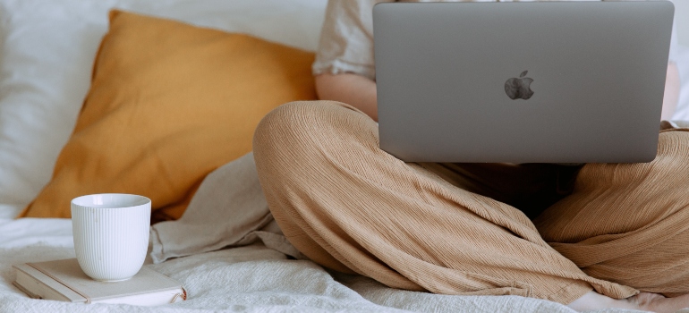 A person using a laptop to find how to plan a long distance move from Seattle