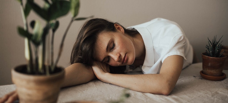 An exhausted girl sleeps as one of the ways to cure moving exhaustion