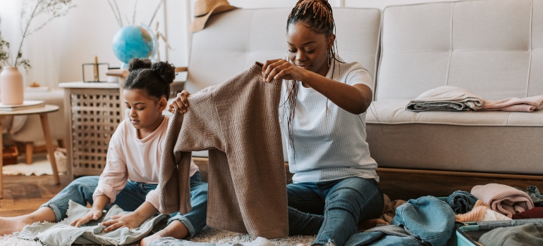 a woman and her daughter sorting clothes