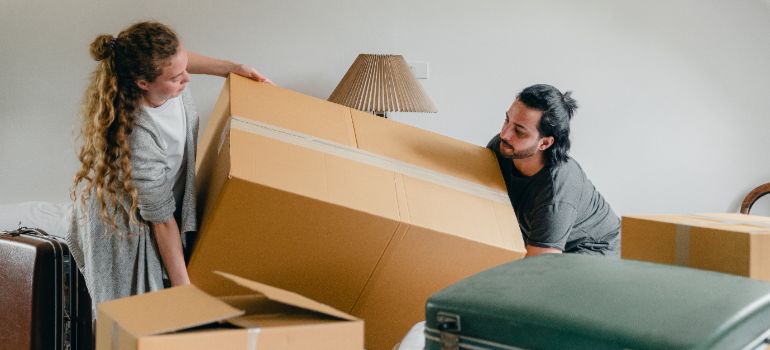 two people moving a large box