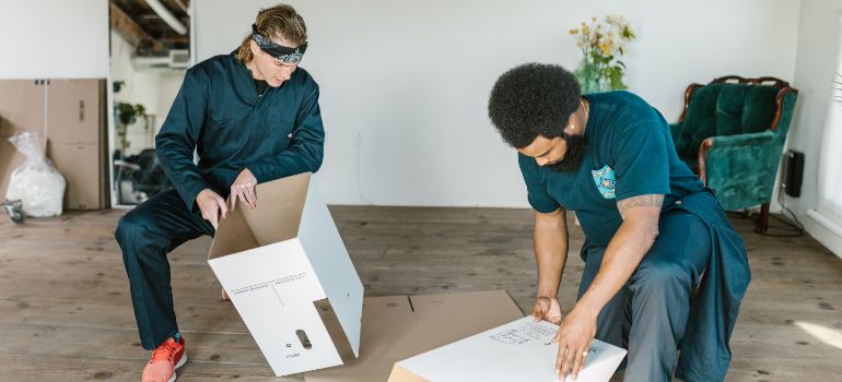 two movers assembling boxes