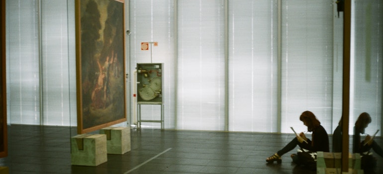 a person sitting in front of a picture