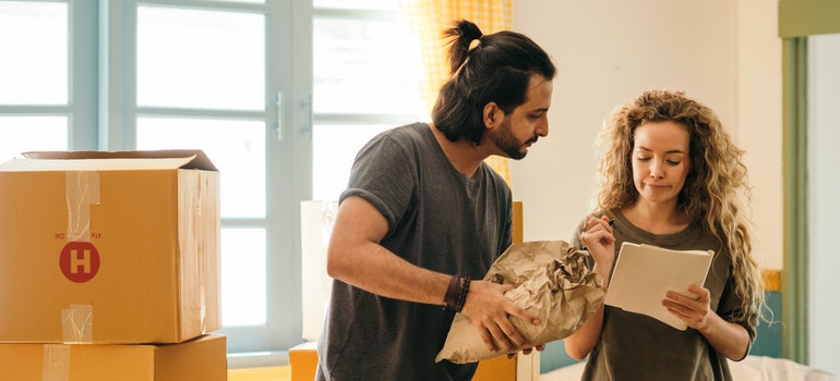 a man and a woman while packing for moving from Seattle to NYC