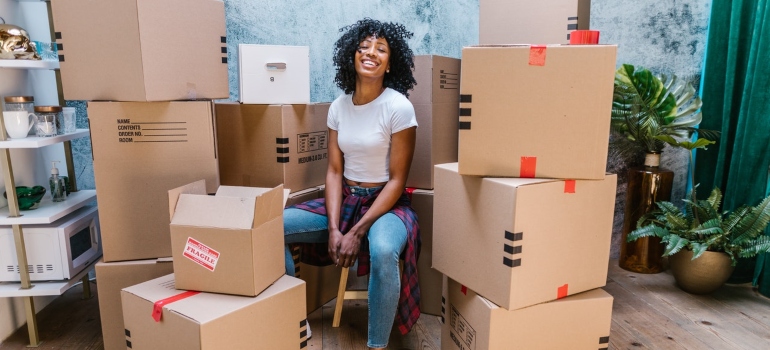a girl sitting between boxes