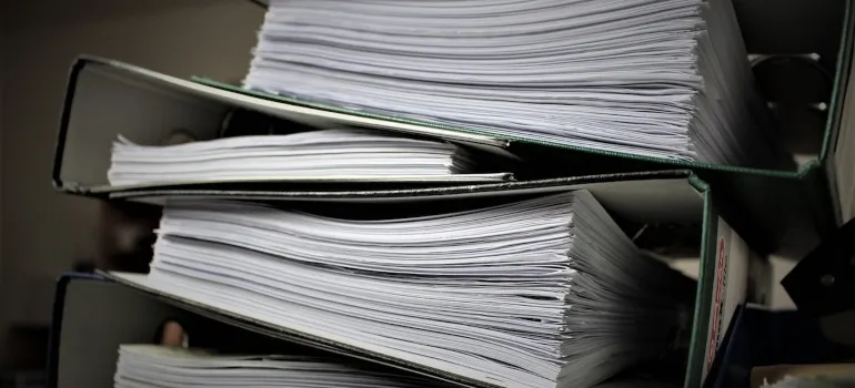 A stack of documents, which is good to collect before moving by yourself to Seattle