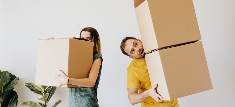 a couple holding boxes