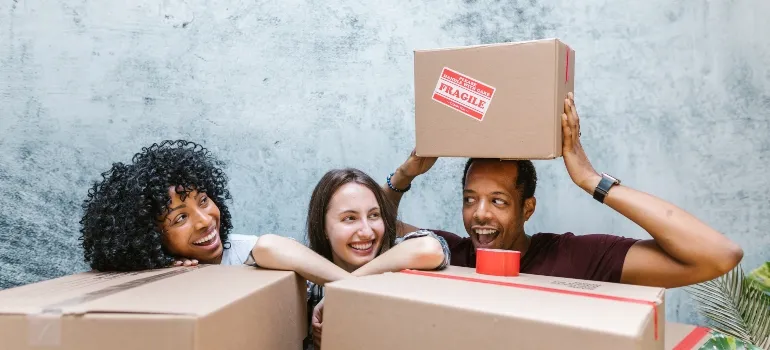 Happy people around boxes