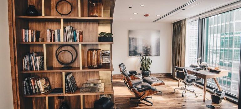 A wooden bookshelf with books in the living room