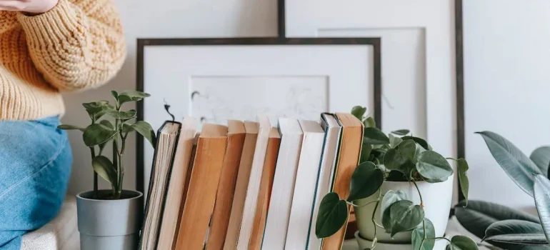 A woman sitting near her books