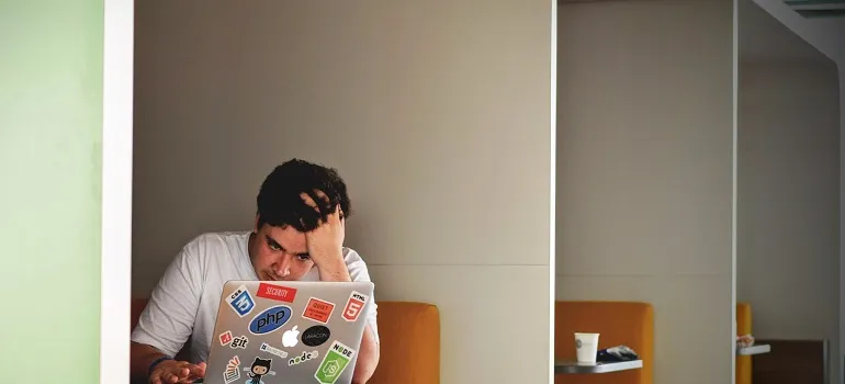 A man looking for a job on a laptop