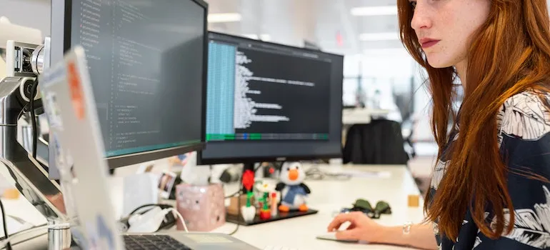 a woman coding on a computer after moving from Bainbridge Island to Bellevue