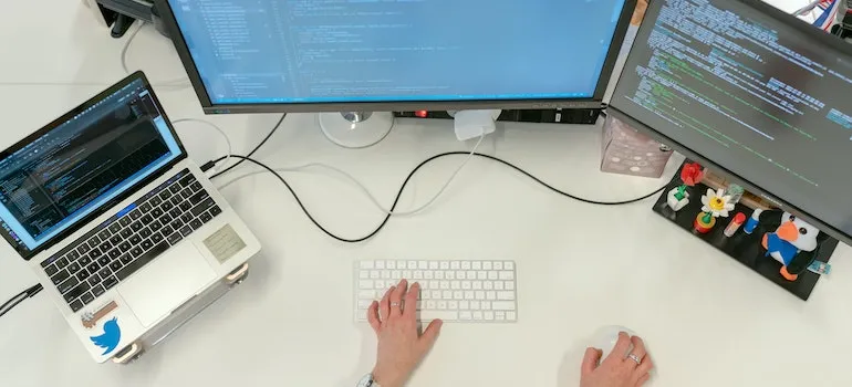 a woman doing work on a laptop and computer