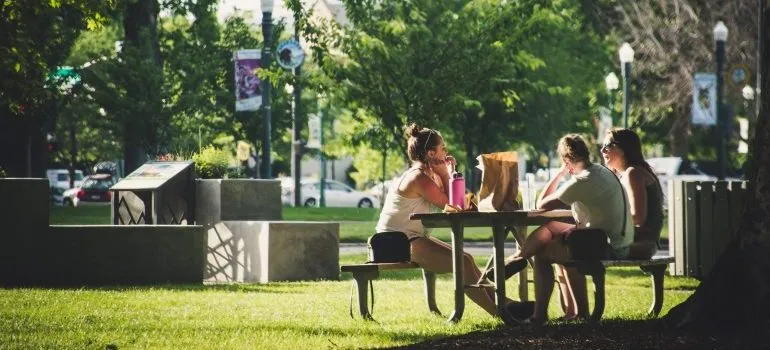 Women sitting on the bench, discussing why people move to Redmond WA