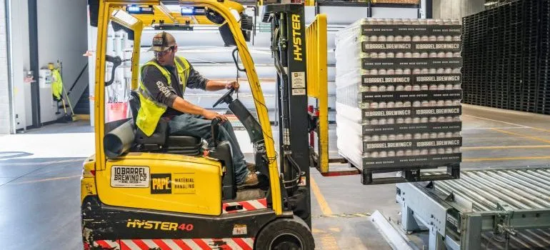 A man operating heavy equipment and preparing it for heavy equipment transport process