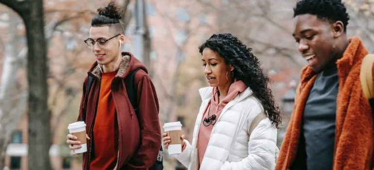 Three friends walking and talking about why West Seattle is ideal for young adults