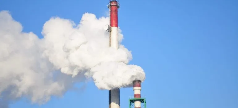 Smoke stacks against blue sky