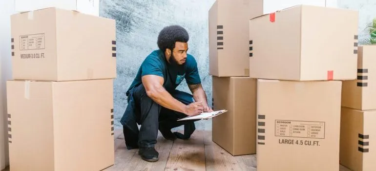 Man checking boxes and taking notes