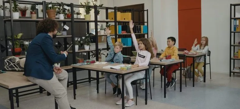 Students raising their hands in class