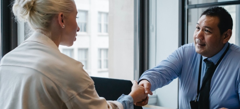 Two people shake hands