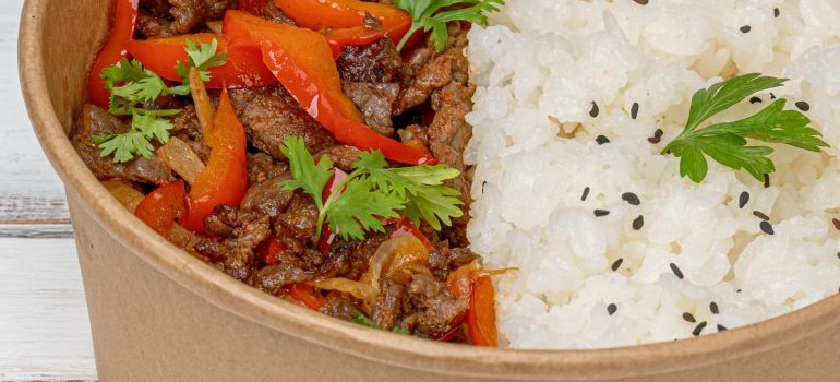 Meat, rice and herbs in a bowl after planning your moving day meals