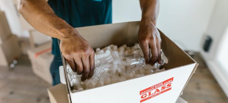 A man packing glasses for PortaBox self storage