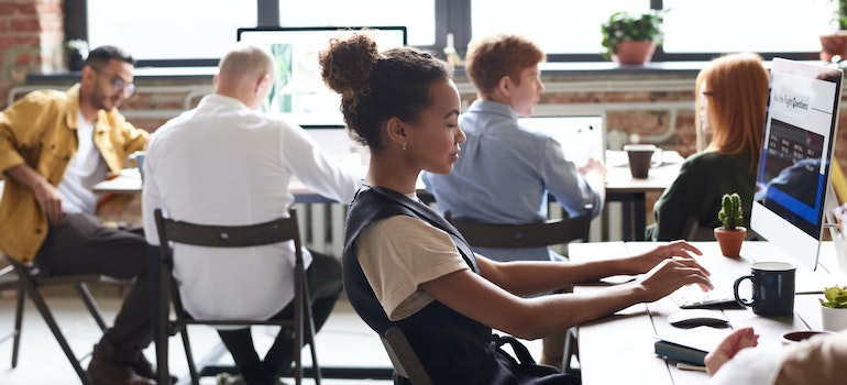 Woman working on her computer efficiently after decluttering your Seattle office