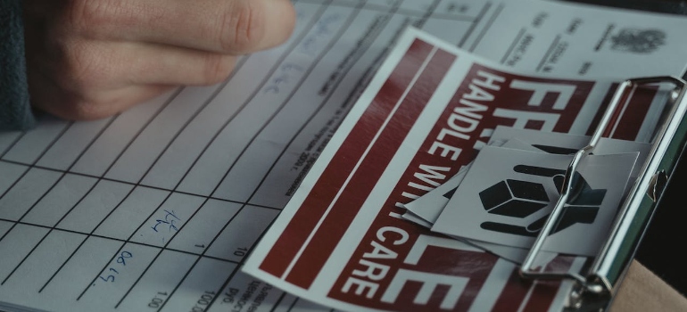 Person writing down on a document for white-glove home delivery services